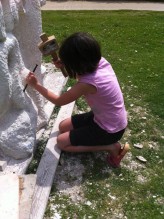 visiting family learning to use tools to carve stone